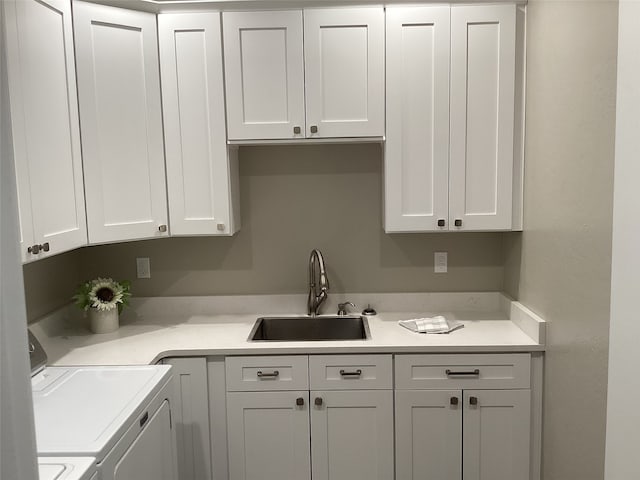 interior space with sink, cabinets, and separate washer and dryer