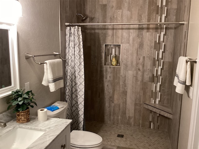 bathroom with vanity, toilet, and curtained shower