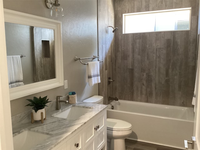 full bathroom featuring vanity, bathtub / shower combination, hardwood / wood-style floors, and toilet