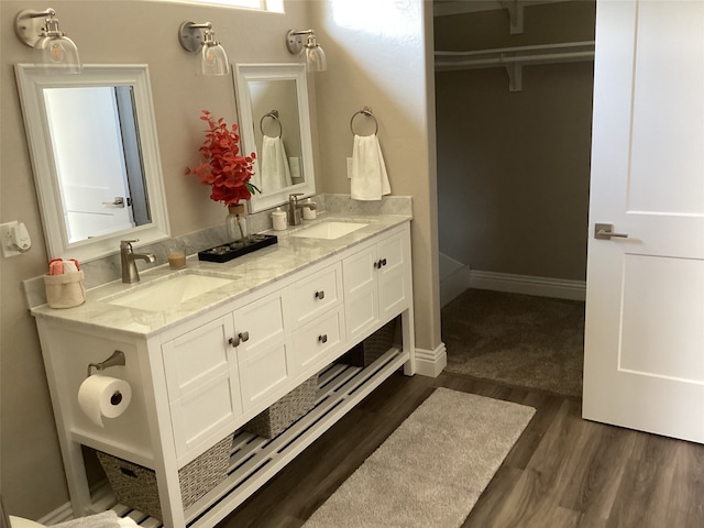 bathroom featuring hardwood / wood-style floors and dual bowl vanity