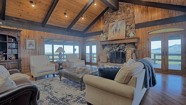 living room with beam ceiling, french doors, high vaulted ceiling, wooden walls, and wood ceiling