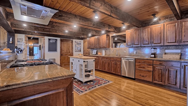 kitchen featuring appliances with stainless steel finishes, tasteful backsplash, beam ceiling, light hardwood / wood-style flooring, and a kitchen island