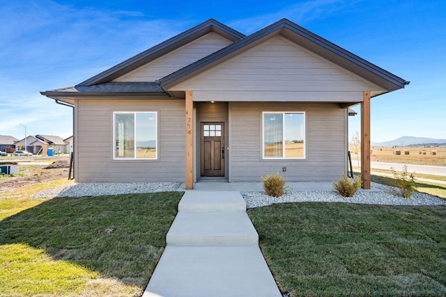 bungalow-style home featuring a front lawn