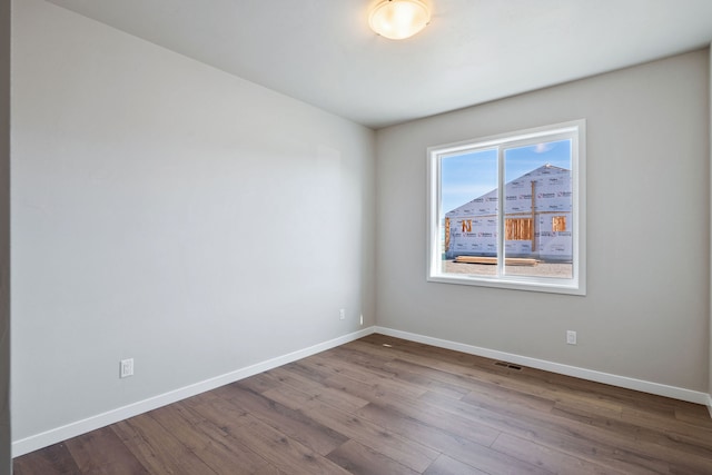 spare room featuring hardwood / wood-style floors