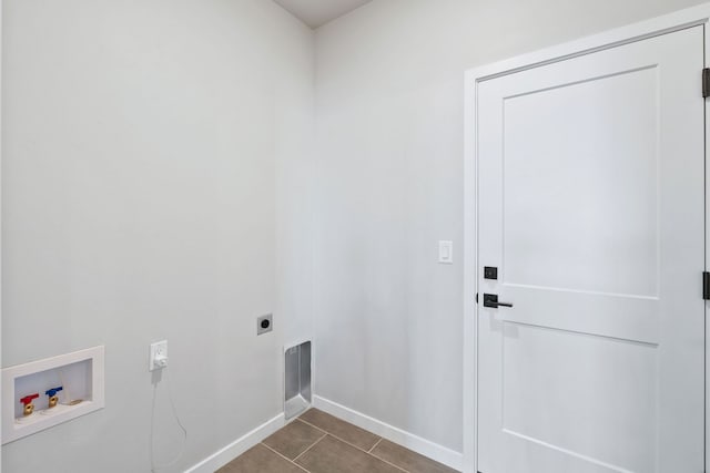 laundry room featuring dark tile patterned floors, hookup for an electric dryer, and hookup for a washing machine