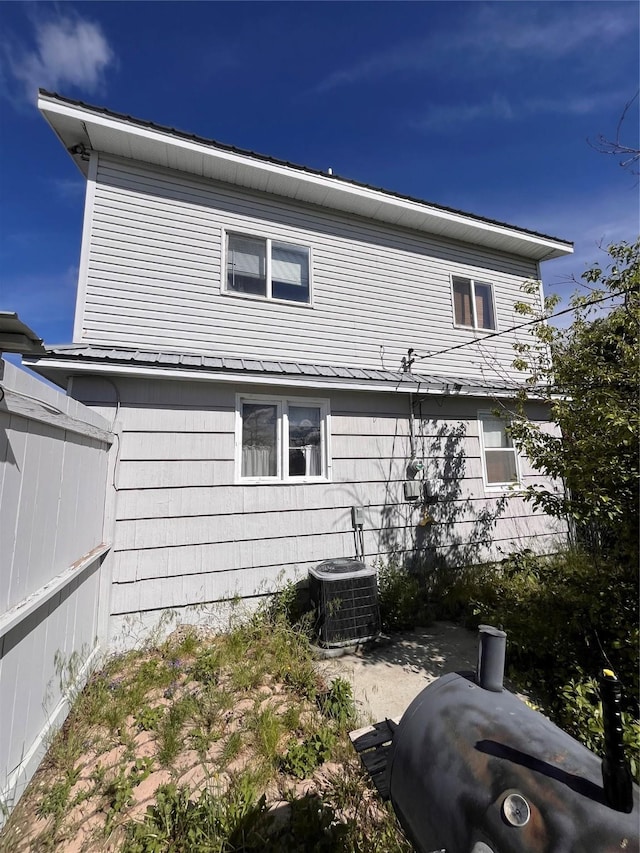 back of house with central air condition unit