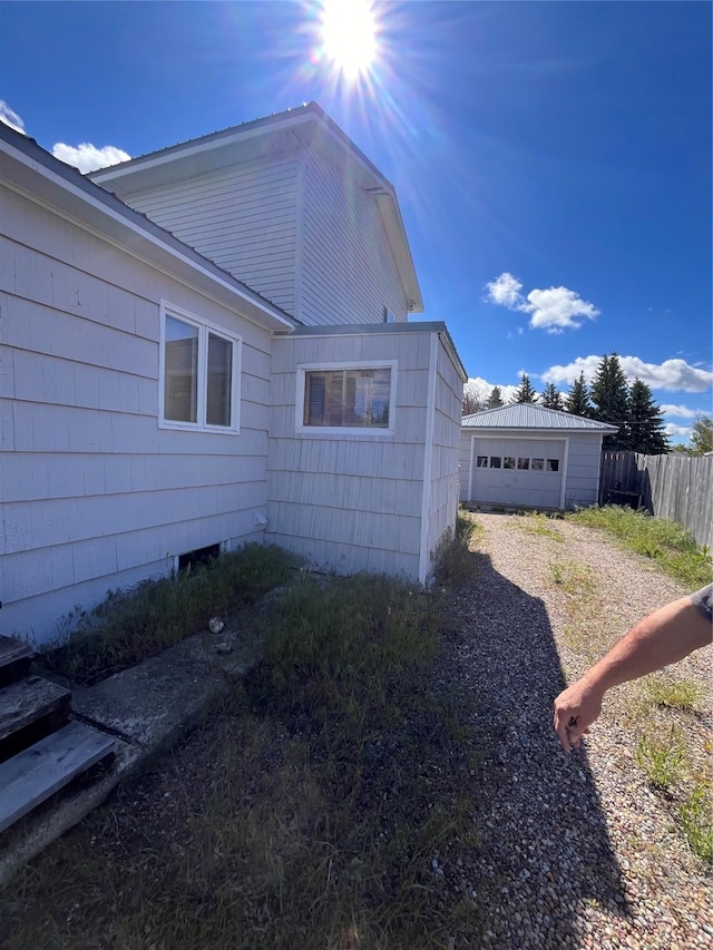 view of side of property with a garage and an outdoor structure