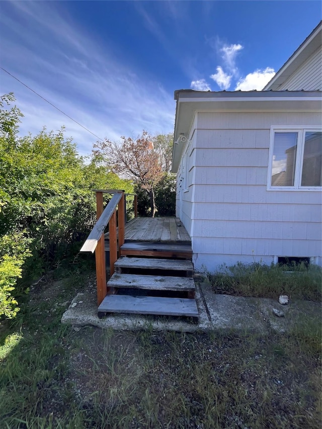 view of side of home featuring a wooden deck