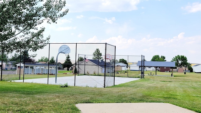 view of sport court featuring a lawn