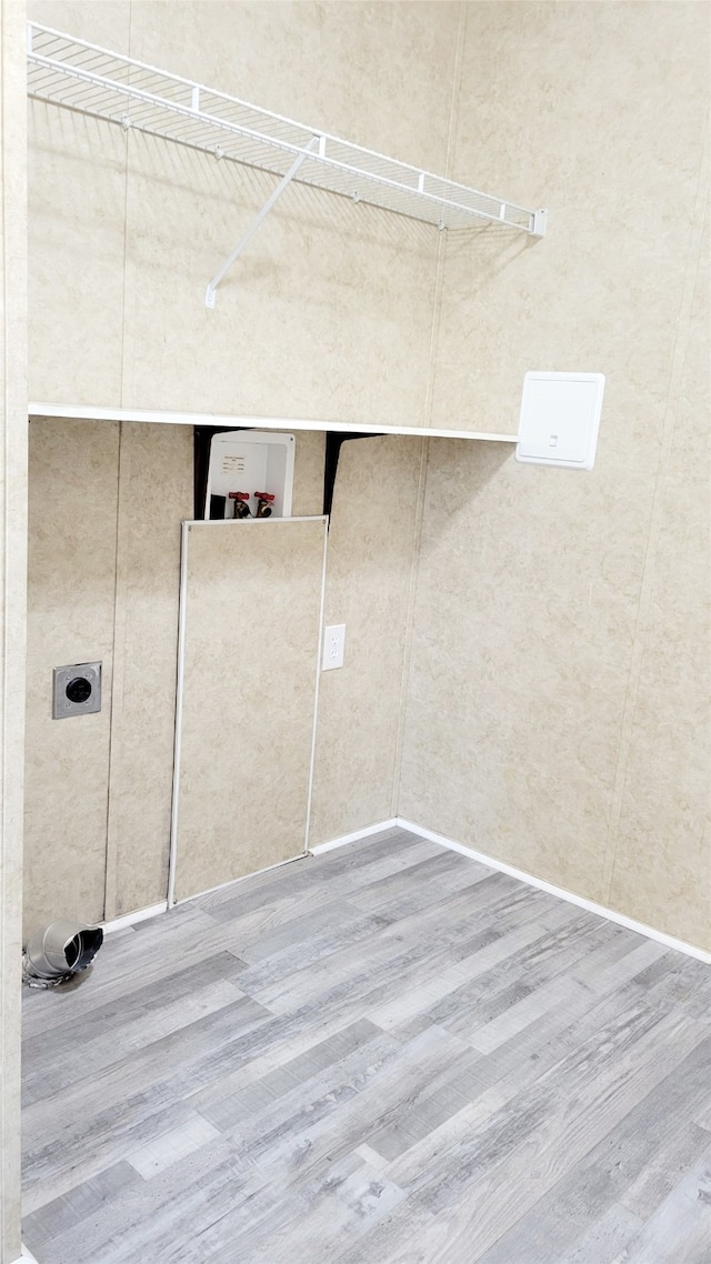 clothes washing area featuring washer hookup, hardwood / wood-style floors, and hookup for an electric dryer