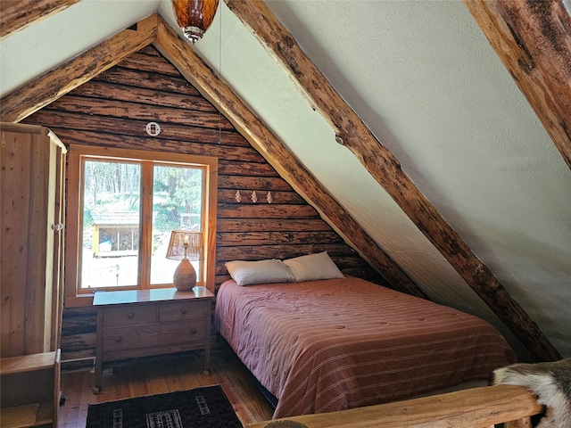 bedroom featuring log walls, hardwood / wood-style flooring, and lofted ceiling