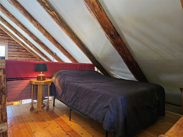 bedroom featuring lofted ceiling and hardwood / wood-style floors