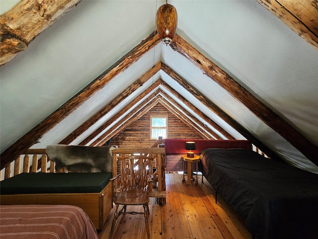 bedroom featuring hardwood / wood-style flooring and lofted ceiling with beams