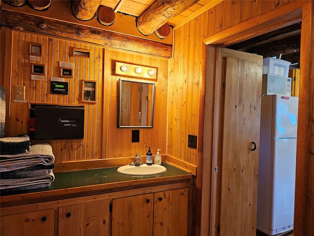 bathroom with wood walls and vanity