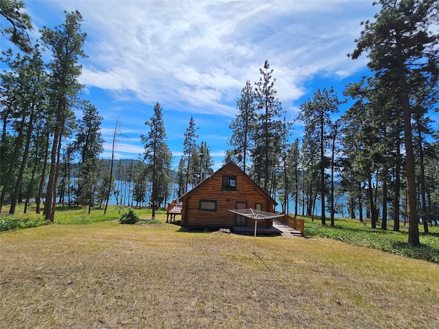 view of home's exterior featuring a deck and a lawn