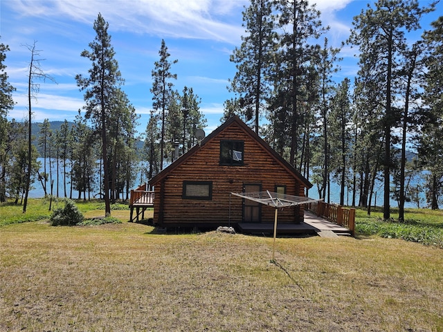 view of side of home with a yard and a wooden deck