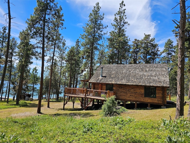 view of home's exterior with a deck and a yard