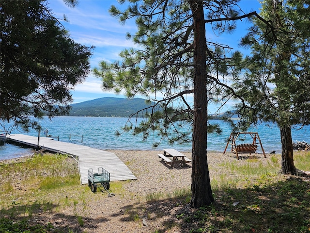 view of water feature with a mountain view and a dock