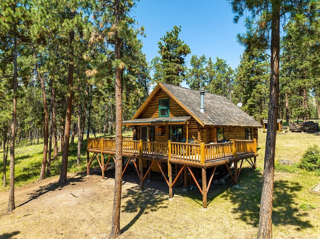 exterior space featuring a wooden deck and a yard