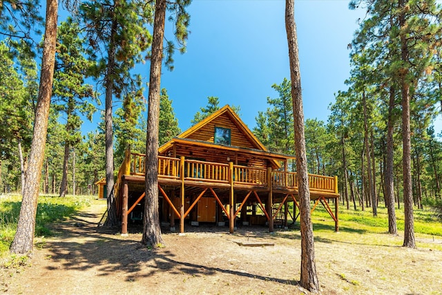 rear view of property featuring a wooden deck