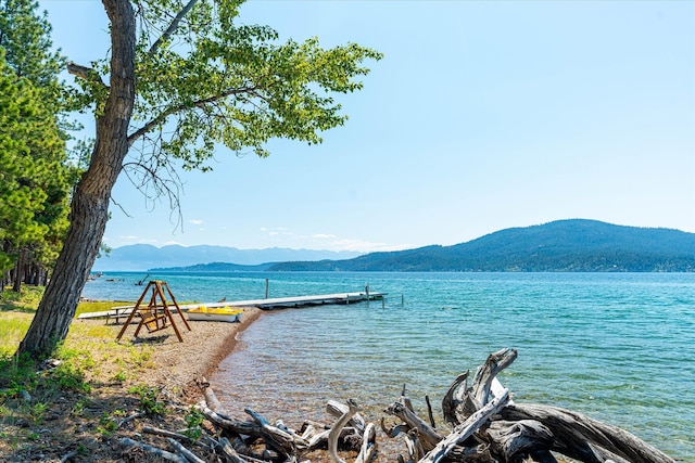 water view with a dock and a mountain view