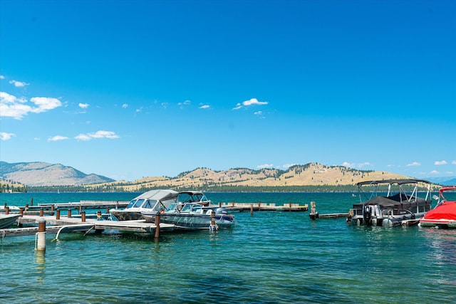 dock area featuring a water and mountain view