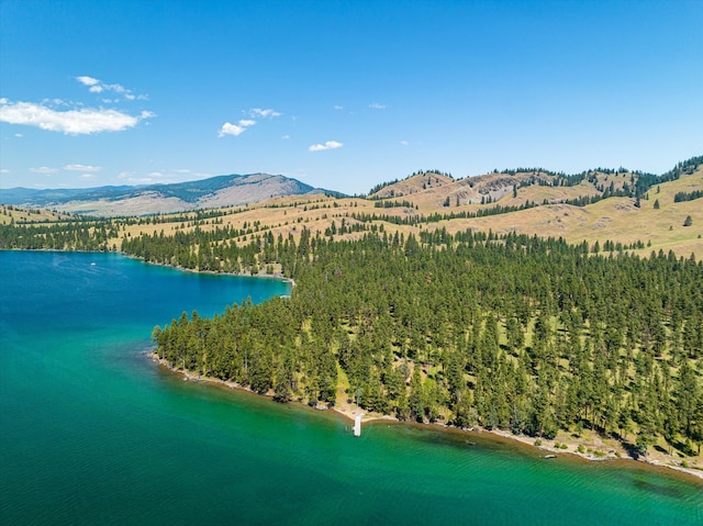 aerial view featuring a water and mountain view