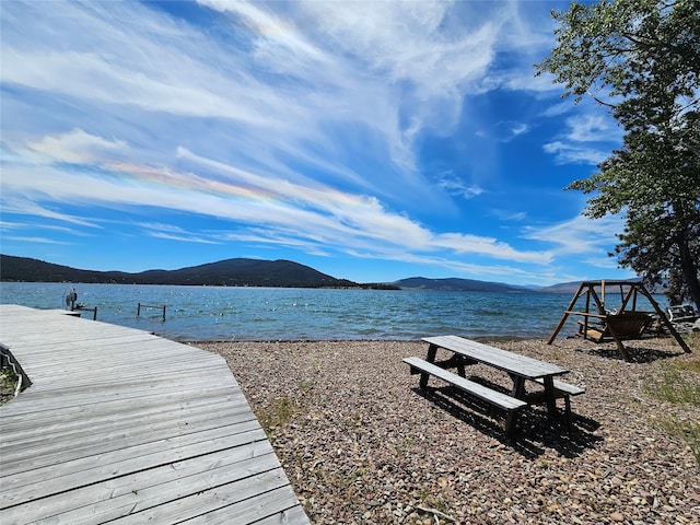 view of dock featuring a water and mountain view