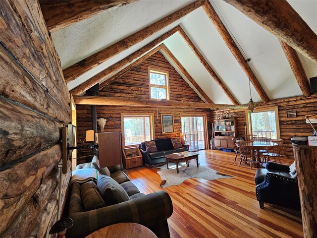 living room featuring high vaulted ceiling, beam ceiling, hardwood / wood-style floors, and plenty of natural light