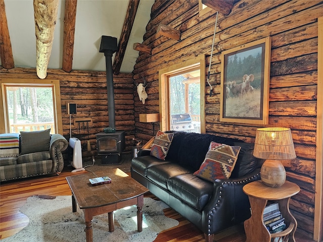 living room with a wood stove, rustic walls, beam ceiling, high vaulted ceiling, and wood-type flooring