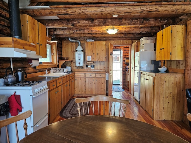 kitchen with a wealth of natural light, white gas range oven, and beam ceiling