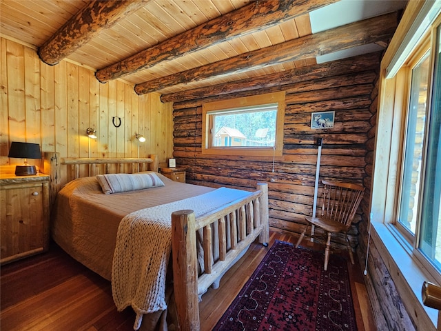 bedroom with log walls, hardwood / wood-style flooring, and beam ceiling