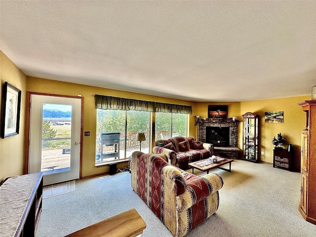 living area with light carpet, a fireplace with raised hearth, and a textured ceiling