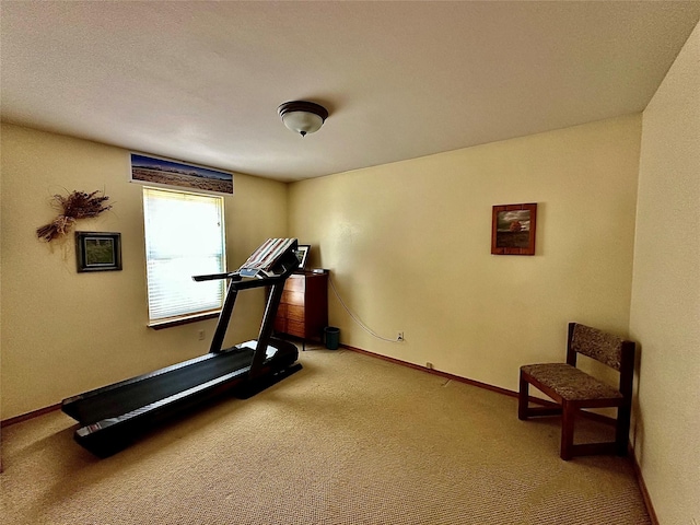 workout room featuring carpet and baseboards