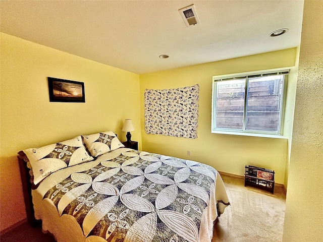 bedroom featuring carpet floors, visible vents, and baseboards