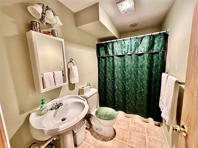 full bath with tile patterned flooring, a sink, and toilet