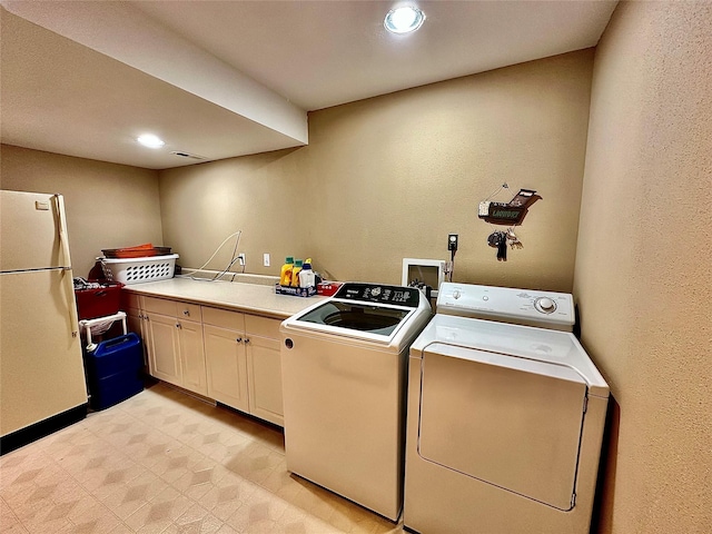 laundry area with recessed lighting, separate washer and dryer, baseboards, cabinet space, and light floors