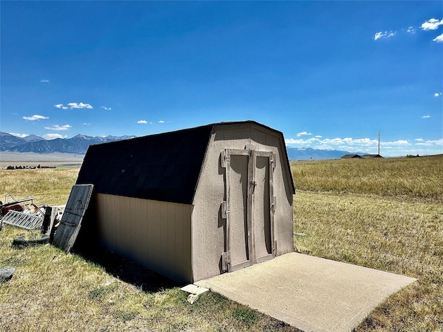 view of shed featuring a rural view and a mountain view