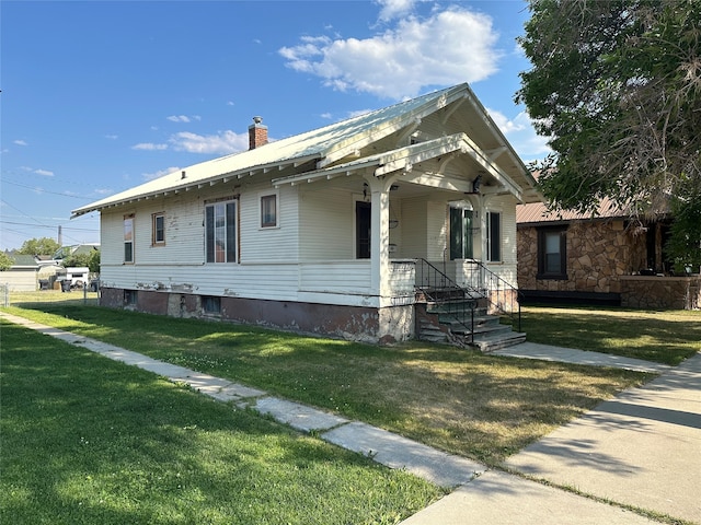 bungalow-style house featuring a front yard