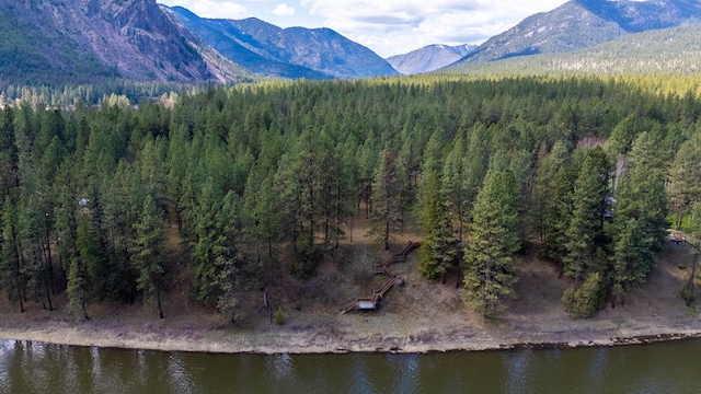 bird's eye view with a forest view and a water and mountain view