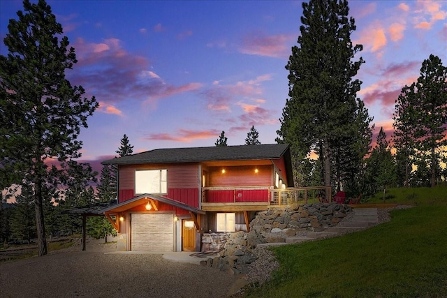 view of front of property with driveway, an attached garage, and a lawn