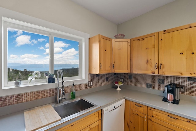 kitchen featuring sink, tasteful backsplash, a mountain view, white dishwasher, and light brown cabinetry