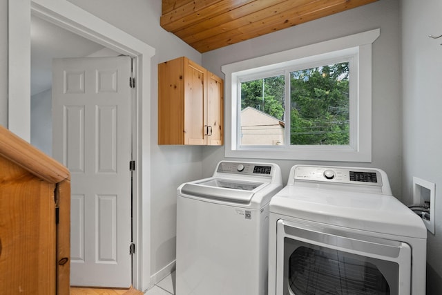 laundry area featuring washer and dryer, cabinets, and wooden ceiling