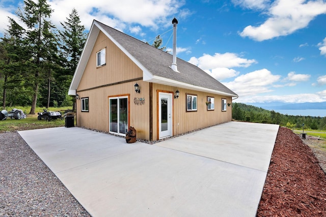 rear view of house featuring a mountain view and a patio