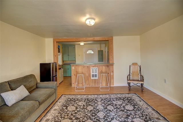 living room with electric panel and hardwood / wood-style flooring