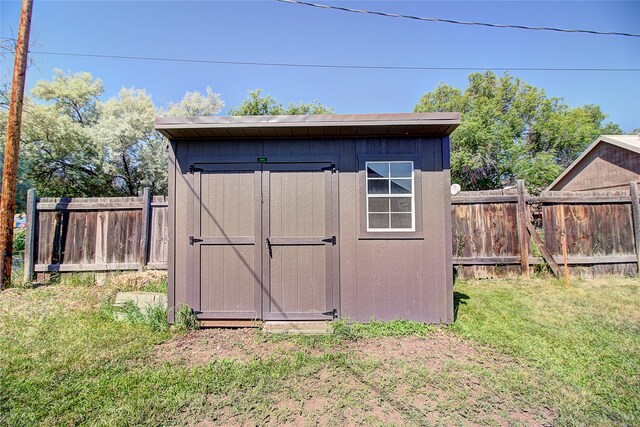 view of outdoor structure featuring a lawn