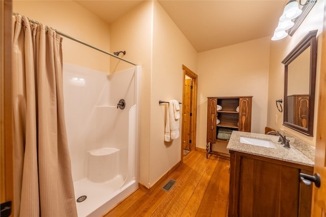 bathroom featuring vanity, hardwood / wood-style floors, and a shower with shower curtain