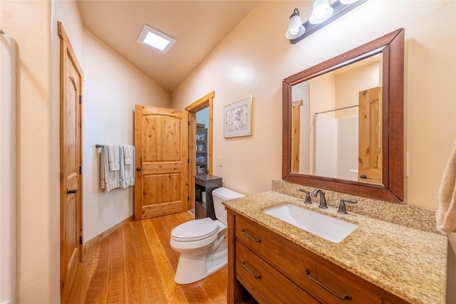 bathroom with lofted ceiling, toilet, a shower, vanity, and hardwood / wood-style flooring