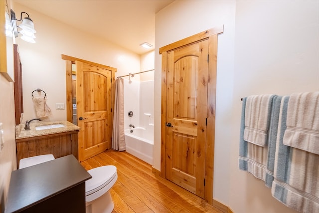 full bathroom with hardwood / wood-style flooring, vanity, toilet, and shower / bath combo