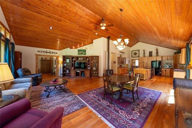 kitchen with a breakfast bar, a center island, black appliances, wooden ceiling, and light hardwood / wood-style flooring